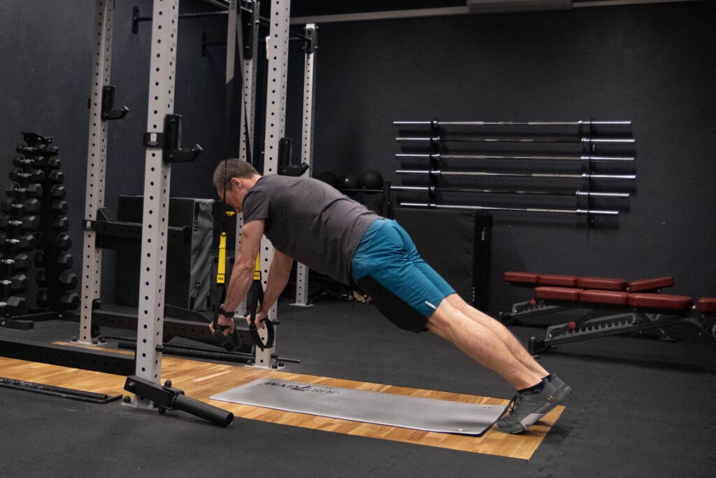 AB Wheel. Jak wykorzystać "kółko" do ćwiczeń brzucha? 7 Podpór z rękami w taśmach